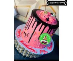 Birthday party cake, in pink with chocolate drippings